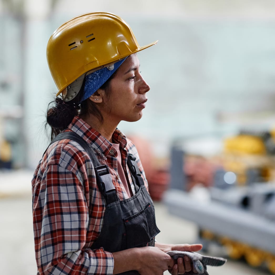 Side view of tired female factory worker